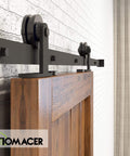 Side view of Black Rustic Non Bypass Sliding Barn Door Hardware Kit Built Tough For A Single Door 7ft Long Flat Track With T Shape Rollers Heavy Duty Interior Or Exterior Use Premium Carbon Steel With Scratch Resistant Black Coating installed on wooden door on brick wall