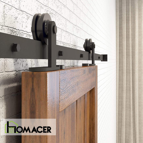 Side view of Black Rustic Non Bypass Sliding Barn Door Hardware Kit Built Tough For A Single Door 7ft Long Flat Track With T Shape Rollers Heavy Duty Interior Or Exterior Use Premium Carbon Steel With Scratch Resistant Black Coating installed on wooden door on brick wall