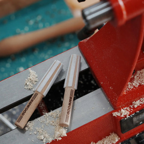 MT2 Cleaner For Wood Lathe Spindles on red lathe, showing handheld wooden cleaning tool for inside MT2 tapers in headstock and tailstock.