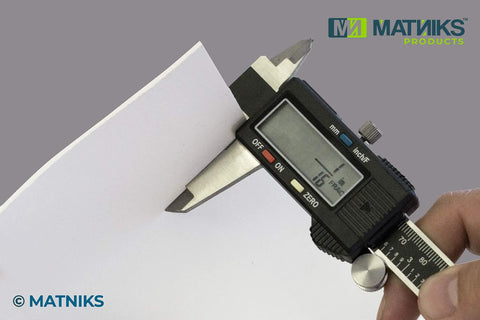 Measuring the thickness of a Food Grade Silicone Rubber Sheet 6 By 6 Inch One Eighth Inch Thick White 3 Pack with caliper