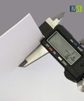 Measuring 1/16 inch thickness of Heavy Duty Food Grade Silicone Rubber Sheets 6By6 Inch 16Thick White 3Pack with caliper.
