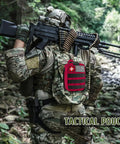 Soldier in woodland with tactical gear and red 170 Piece Survival First Aid Kit With Trauma Gear And Emergency Medical Supplies
