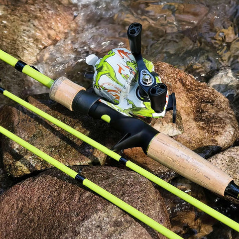 Spincast Reel And 5.9 Foot Two Piece Fishing Rod Combo With Pre Spooled Line on rocks near water with cork handles and graphite reel seat