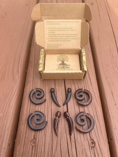 Spiral Fake Gauge Earrings Set In Black With Organic Wood And 316L Surgical Steel, showing two pairs on wood surface with box