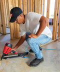 Person using nailer with 30 Degree Paper Collated Ring Shank Framing Nails With Round Head Galvanized For Outdoor Use 3 Inch By.120 Inch