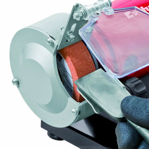 Close-up of Shop Ready Double Wheel Bench Grinder With Adjustable Spark Arresters and Heavy Duty Tool Rests in use sharpening metal.