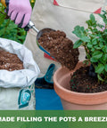 Heavy Duty Bend Proof Stainless Steel Potting Scoop With 1 Cup Capacity Large Volume Garden Hand Shovel Wood Handle Dirt Trowel For Transplanting Cultivation Composting And Planting used to transfer soil into a pot with plants.