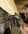 Mechanic using 5102MAX Air Die Grinder with Right Angle Head on vehicle surface, ergonomic grip visible, in repair shop.