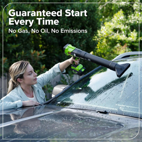 Woman using a green and black 270 CFM electric leaf blower on a car windshield to clean dirt, showcasing Tackle Stubborn Weeds Fast With This Heavy Duty 24V Brushless String Trimmer And 270 Cfm Electric Leaf Blower Combo Plus Reliable 20 Ah Battery Pack For Epic Yard Hustle.