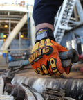 KONG SDX2 05 XL Oil And Gas Safety Impact Gloves Orange Heavy Duty in use on industrial equipment, showing metacarpal and knuckle protection.