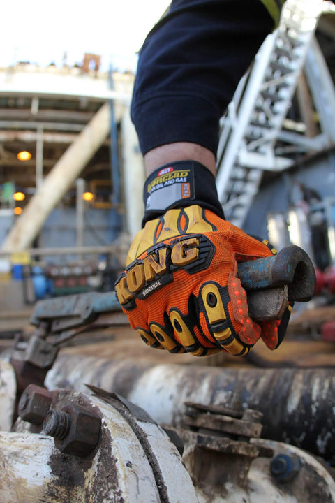 KONG SDX2 05 XL Oil And Gas Safety Impact Gloves Orange Heavy Duty in use on industrial equipment, showing metacarpal and knuckle protection.