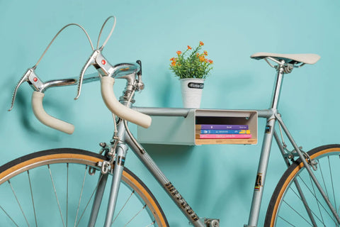 Wall Mounted Bike Rack With Bamboo Shelf For Indoor Storage And Decor, Minimalist Bicycle Hanger With books and plant.
