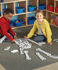 Children assembling the Hands On Skeleton Floor Puzzle for Classrooms and Home, a STEM anatomy activity with fifteen foam bones.