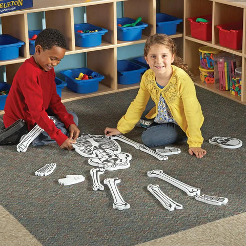 Children assembling the Hands On Skeleton Floor Puzzle for Classrooms and Home, a STEM anatomy activity with fifteen foam bones.