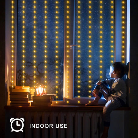 Child sitting by window with Solar Curtain Lights 7.9 Feet By 6 Feet With 144 LEDs Outdoor Waterproof Fairy String Lights glowing