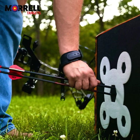 Archer using Yellow Jacket Dual Threat Foam Archery Target Block Up To 350 FPS For Compound Bows And Crossbows in a field.