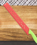 Watermelon Cutter With Sleeve Long Serrated Knife on wooden cutting board, green handle, red sleeve for melon cutting bread and veggie knife