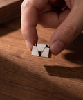 Premium CNC Machining Center Side Clamp With Precision Wedge Stop Block for Milling Operations held in hand over wooden surface.