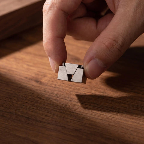 Premium CNC Machining Center Side Clamp With Precision Wedge Stop Block for Milling Operations held in hand over wooden surface.