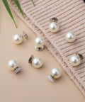 Pack Of 8 Pearl Cleavage Cover Safety Pins For Women Dress Making Styling No Sew Garment Fix Clips arranged on fabric background.