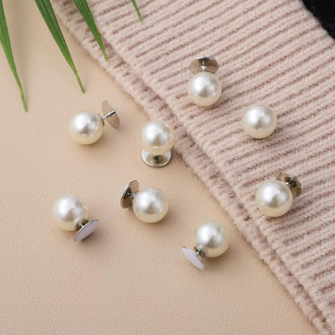 Pack Of 8 Pearl Cleavage Cover Safety Pins For Women Dress Making Styling No Sew Garment Fix Clips arranged on fabric background.