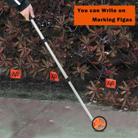 Distance Measuring Wheel With 20 Flag Markers, 40 Inch Reach, 4 Inch Wheel, Measures Feet And Inches outdoors in use.