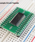 SMD To DIP Breakout PCB Module With SOIC 28 To DIP Adapter on breadboard, dual row header, integrated SMT resistor and capacitor pads.