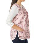 Hassle Free Snap Front Cobbler Apron Vest With Dual Patch Pockets Top Shelf Easy Care Smock in pink, worn by a woman, side view.