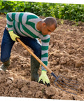 Heavy Duty Manure Fork Handheld Gardening Fork For Efficient Lawn Maintenance And Grass Manure Cleanup tool in use on soil