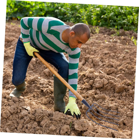 Heavy Duty Manure Fork Handheld Gardening Fork For Efficient Lawn Maintenance And Grass Manure Cleanup tool in use on soil