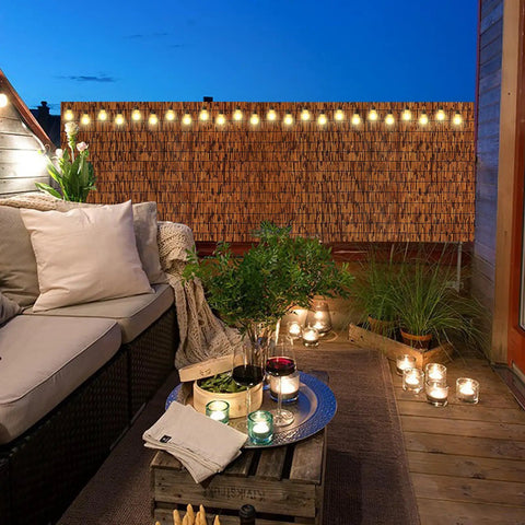 Natural Reed Fence Screen Made From Bamboo For Outdoor Privacy 6 Feet By 16.4 Feet Durable Weatherproof Fencing installed on patio
