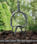 Manual Garden Tiller And Cultivator With Heavy Duty Garden Claw in soil with lush green background