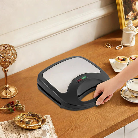 This Sweet 900 Watt Electric Sandwich Maker And Steak Grill Is A Total Game Changer For Your Kitchen Or Office Setup on a stylish wooden table.