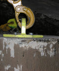 Close-up of a heavy duty concrete screw anchor five eighth inch by four inch hex washer head zinc plated Titen HD pack of 10 installed in cracked concrete