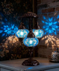 Turkish Mosaic Table Lamp With Built In LED Bulb Three Globe Sea Blue Handmade Moroccan Style Decor Tall 21.3 Inch Glass Mosaic Nightstand Light Artisan Crafted Glass Mosaic With Warm Ambient Glow For Living Room Or Bedroom, casting blue patterns on walls and table.