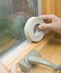 Applying Fingertip Caulking Cord 1/8 Inch By 90 Feet Grey to window frame for weatherproof seal, no caulking gun needed.