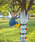 Child using 18 Piece Tree Climbing Holds Set With Six Ten Foot Ratchet Straps For Outdoor Tree Climbing Kit Ideal For Backyard Gyms Obstacle Courses And Nature Play