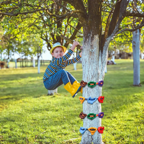 Child using 18 Piece Tree Climbing Holds Set With Six Ten Foot Ratchet Straps For Outdoor Tree Climbing Kit Ideal For Backyard Gyms Obstacle Courses And Nature Play