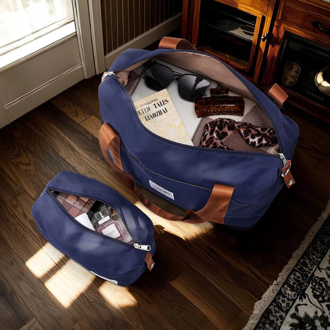 TAKUMI navy 3-piece luggage set with a duffel bag; large carry-on opened to reveal interior, sunglasses, and scarf.
