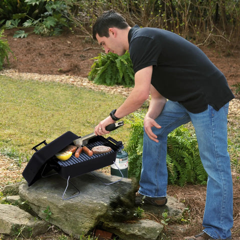 Man grilling on Portable Propane Gas Grill With Convective Heat, One Burner, 190 Square Inches Of Cooking Space for camping