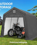 Tough As Nails 10 By 10 Outdoor Portable Storage Shed With Heavy Duty Steel Frame And Roll Up Door Garage Shelter For Generator Vehicles And Motorcycle All Weather Storage Solution displaying outdoor storage use with motorcycle and mower inside.