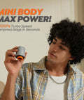Person holding a grey and orange pump from Cordless Vacuum Storage Bags 20 Pack With Rechargeable Wireless Pump Portable Space Saver.