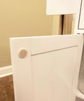 Three-Eighths Inch Round Mini Self-Stick Furniture Felt Pads For Hard Floors installed on cabinet door