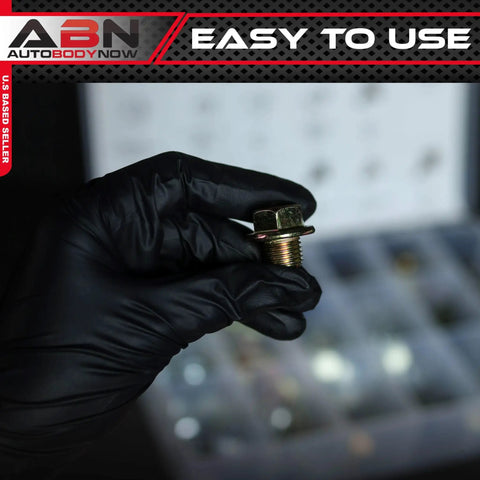 Close-up of a hand holding a plug from the Oil Drain Plug Kit 76 Piece Assortment With SAE And Metric Plugs And Washer Gasket Set