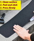 Applying Self Adhesive Non Slip Stair Tread Tape 15 Pack Pre Cut 32 By 6 Inch Black Stair Step Strips Anti Slip Traction Tape by hand.
