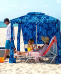 Beach Cabana Canopy 6.5 Feet By 6.5 Feet, Easy Set Up And Take Down, Portable Sun Shade With Sand Pockets And Side Wall, Water Resistant Beach Shelter In Coral Tropical providing shade on a sandy beach
