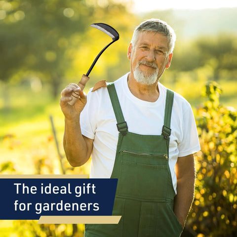 Gardener holding Nejiri Kama Weeding Sickle Tool With Razor Sharp 4 Inch Drop Forged Blade For Quick Weed Removal in a garden