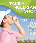 Golfer drinking from Mulligan Shots Golf Ball Shot Glass on course with slogan "Take a Mulligan Shot!" visible.