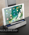 Heavy Duty Electric Standing Desk Converter With Monitor Mount And Wide Keyboard Tray featuring a built-in storage space for devices.