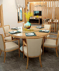 Heavy Duty Tempered Glass Lazy Susan Rotating Serving Plate With Hella Smooth Aluminum Bearing Swivel Base Built Damn Tough For Kitchen Countertops Banquet Tables And House Parties on a round wooden dining table with chairs.